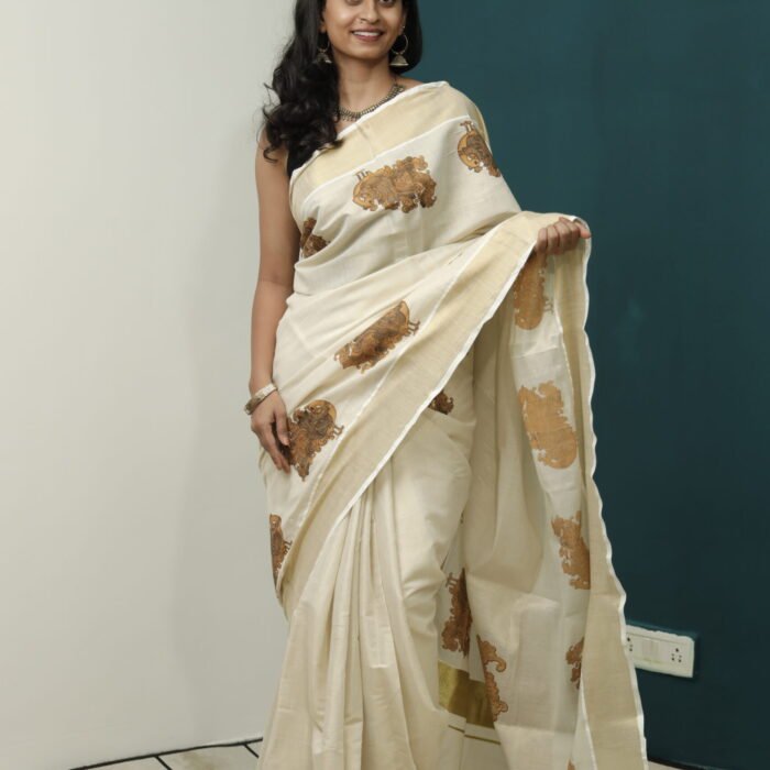 The Elegance of Kerala Saree: Unveiling the Cream Beauty with Peacock Motif, Golden Border, and Red Kasavu